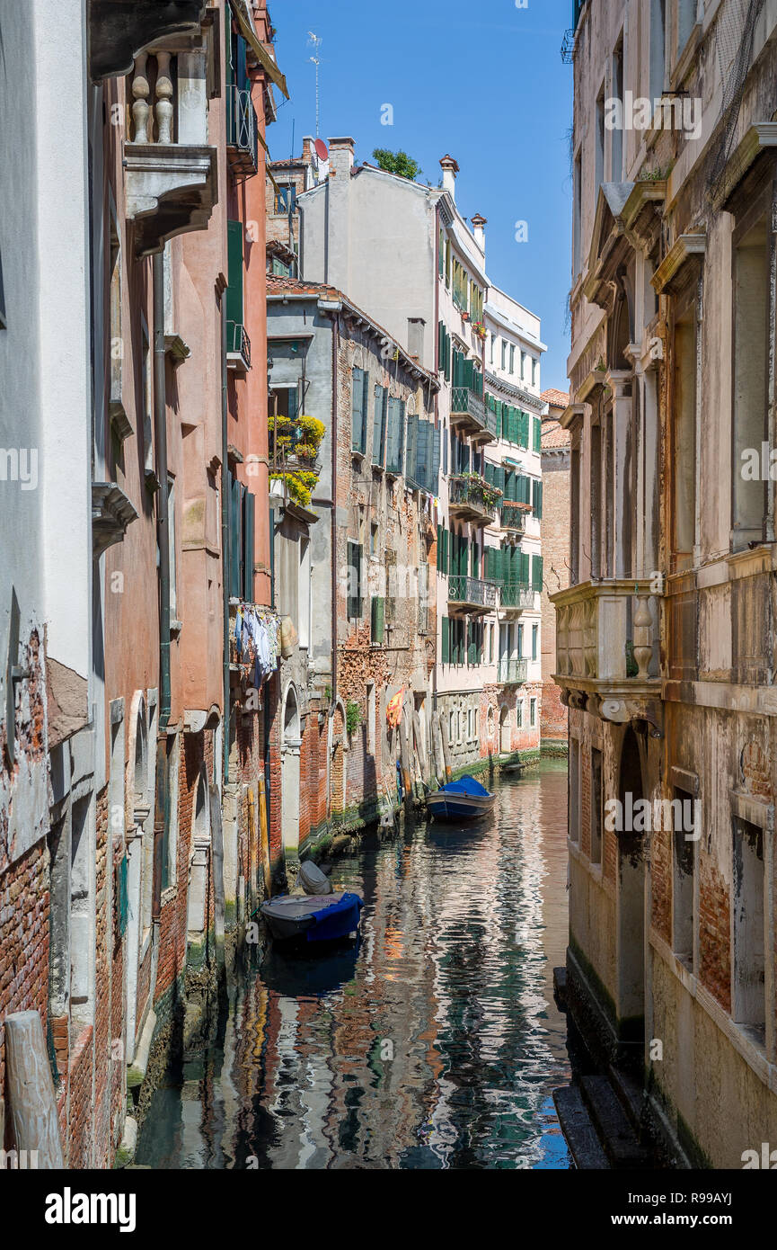 Tiny Venice old town channel with beautiful reflections of old houses on the water. Veneto, Italy. Stock Photo