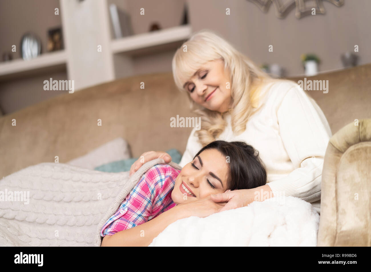 Portrait Of Beautiful Daughter Covered In Cozy Blanket Napping On