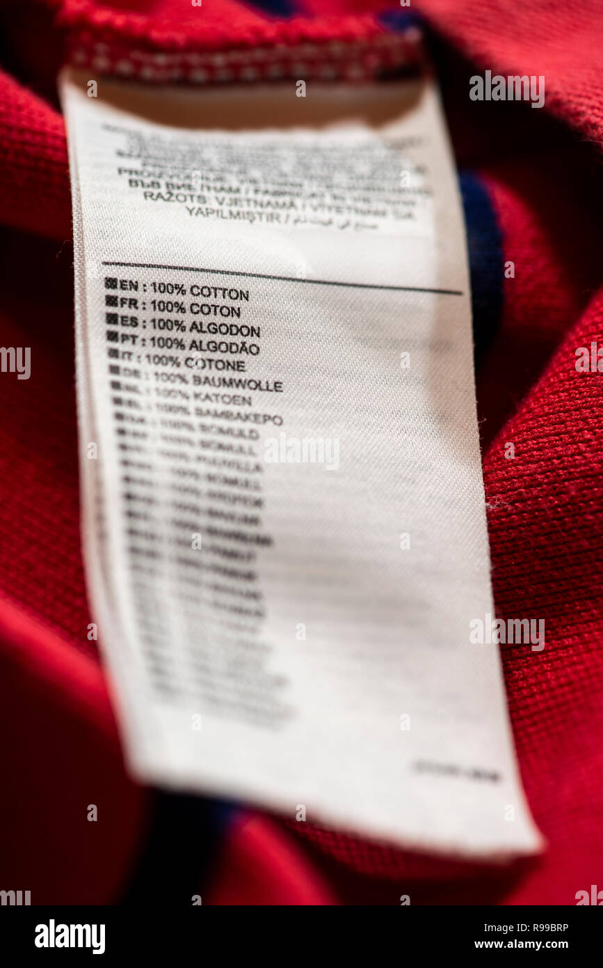 Label inside on red cotton shirt. Text 100 cotton on many languages