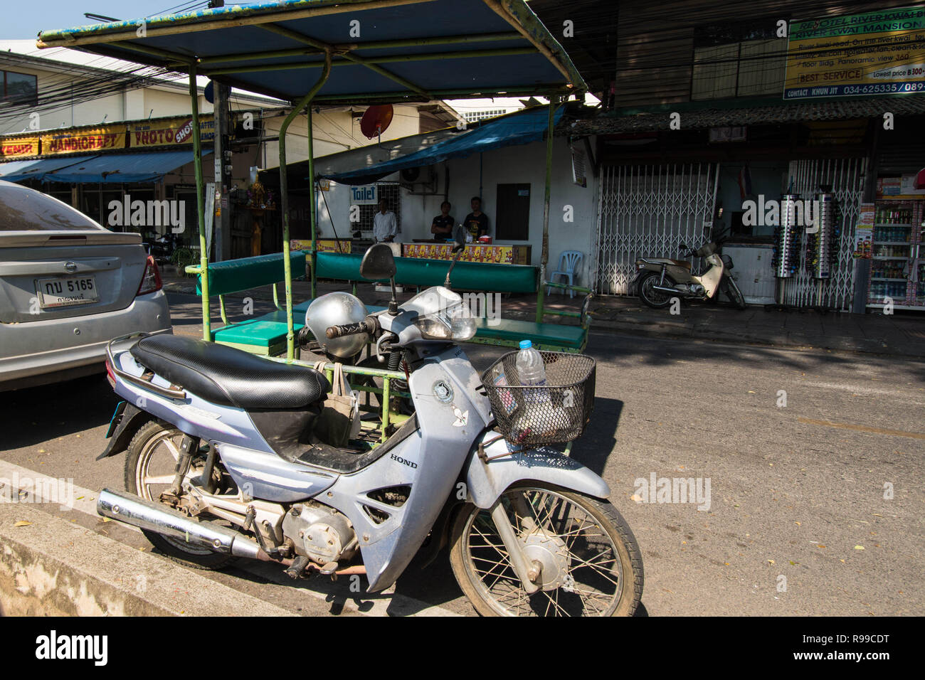 Motor bike in Thailand Bangkok house home scooter parked factory workers work local canopy roof