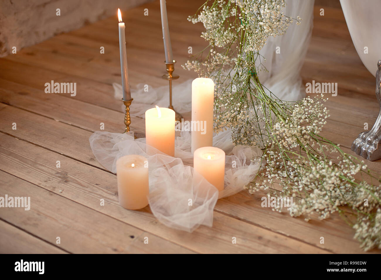 a bath tub filled with lots of candles next to a sink filled with flowers  and candles next to a bath tub filled with roses and candles. generative ai  Stock Illustration