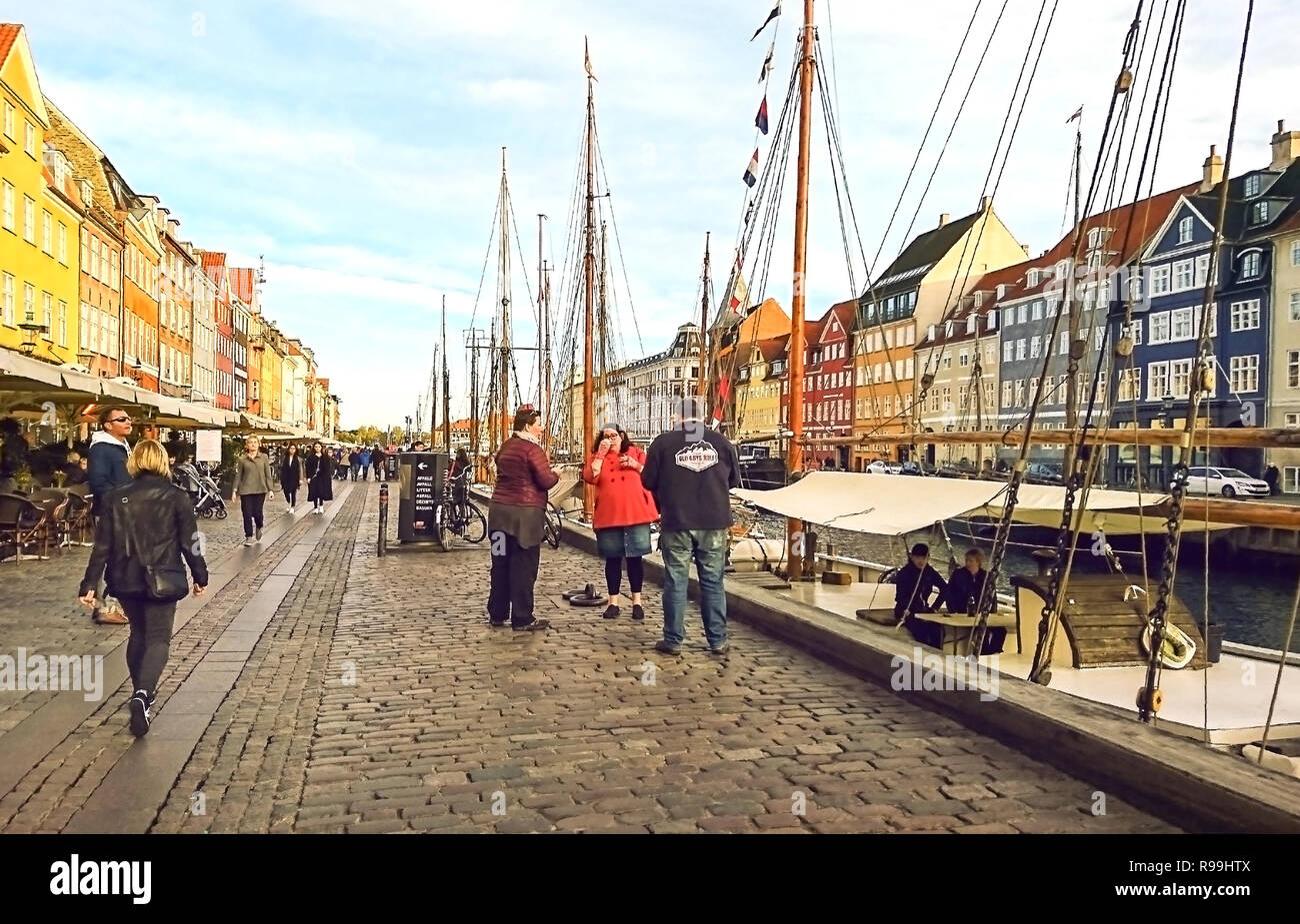 Copenhagen, Denmark - September 25, 2018: Scenic view of Nyhavn pier with colored buildings, ships, yachts and other boats in the Old Town. Stock Photo