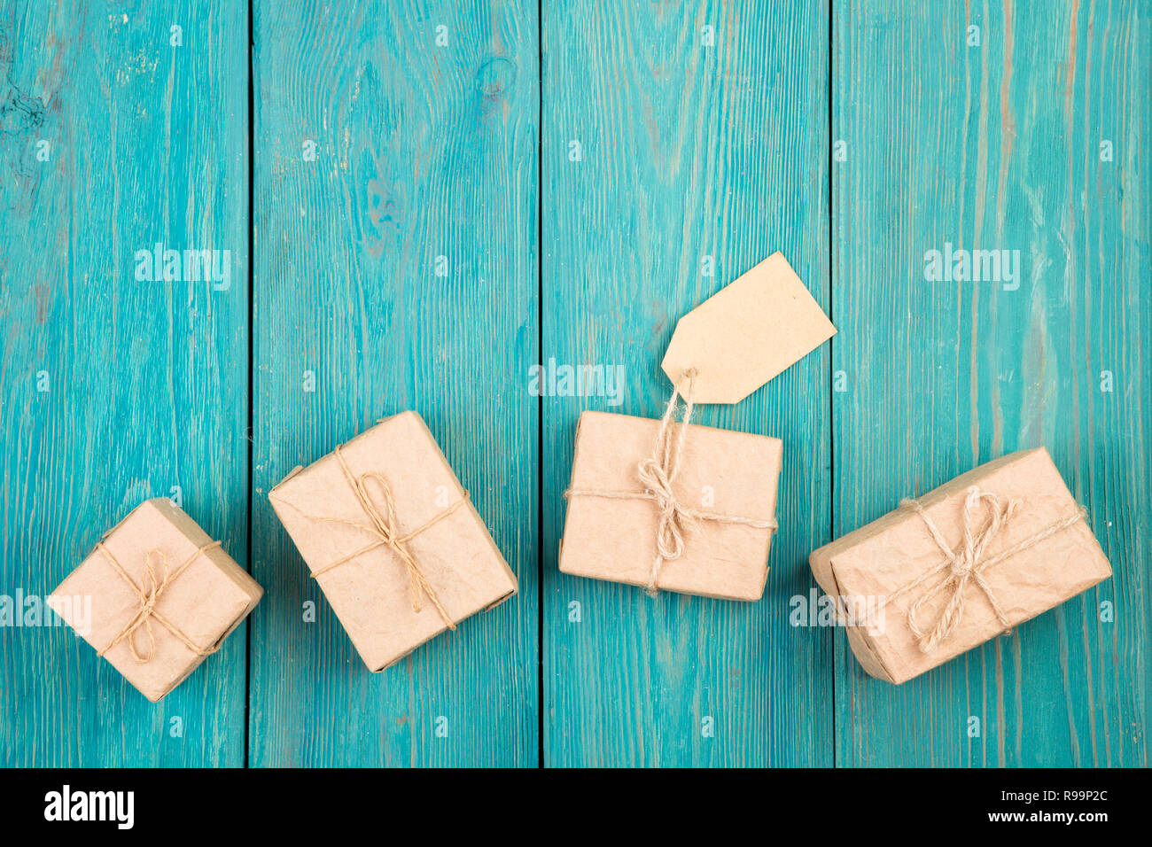 Gift boxes and tag on blue wooden table Stock Photo