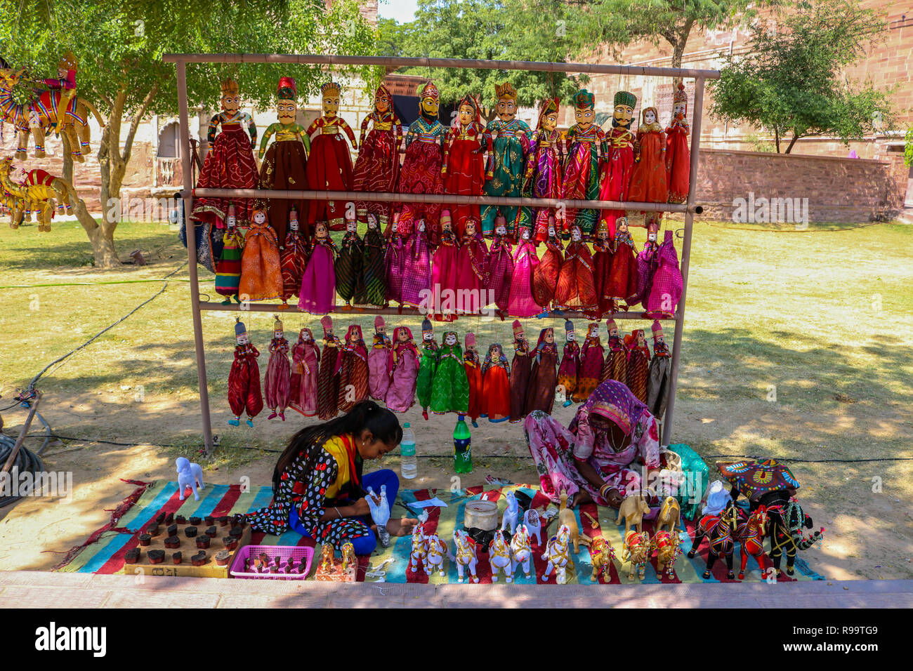 Indian Women making Kathputli (Rajasthani puppets) at a street shop, Mehrangarh Jodhpur, Rajasthan. Stock Photo