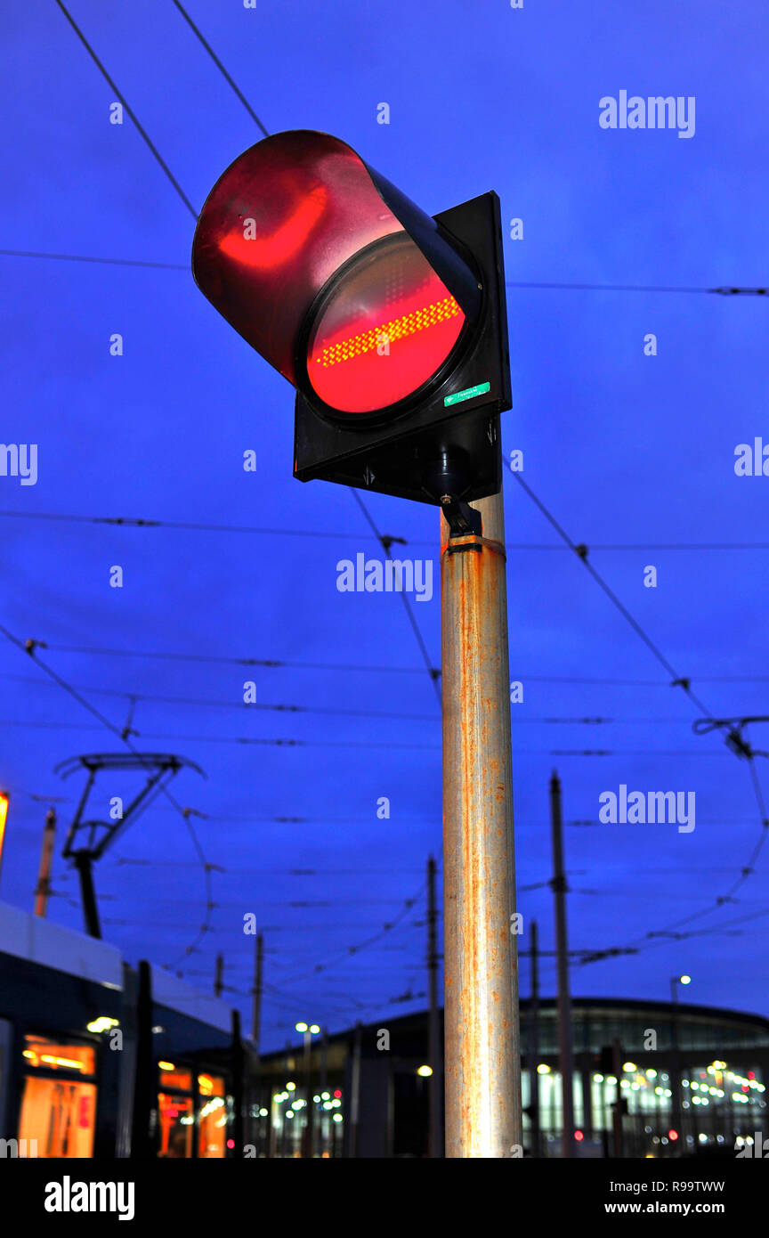 Red stop sign for incoming traffic in front of tram leaving depot in ...