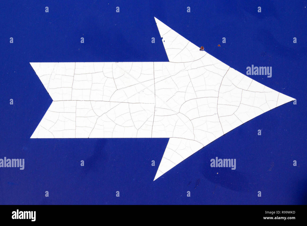 White arrow on blue background Stock Photo