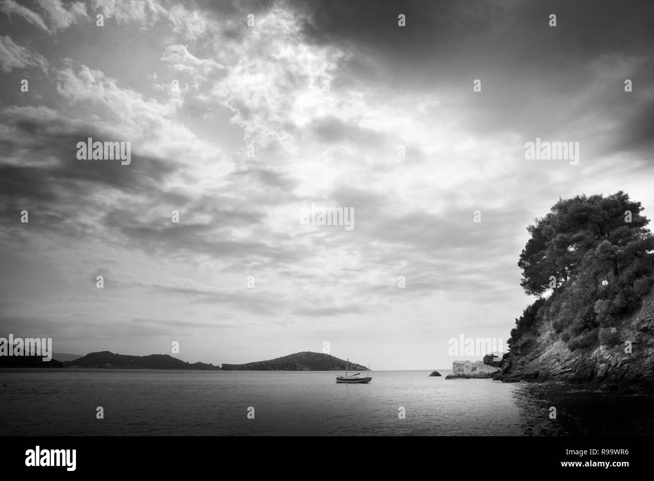 Wooden rowing boat in a bay, Skiathos, Greece Stock Photo