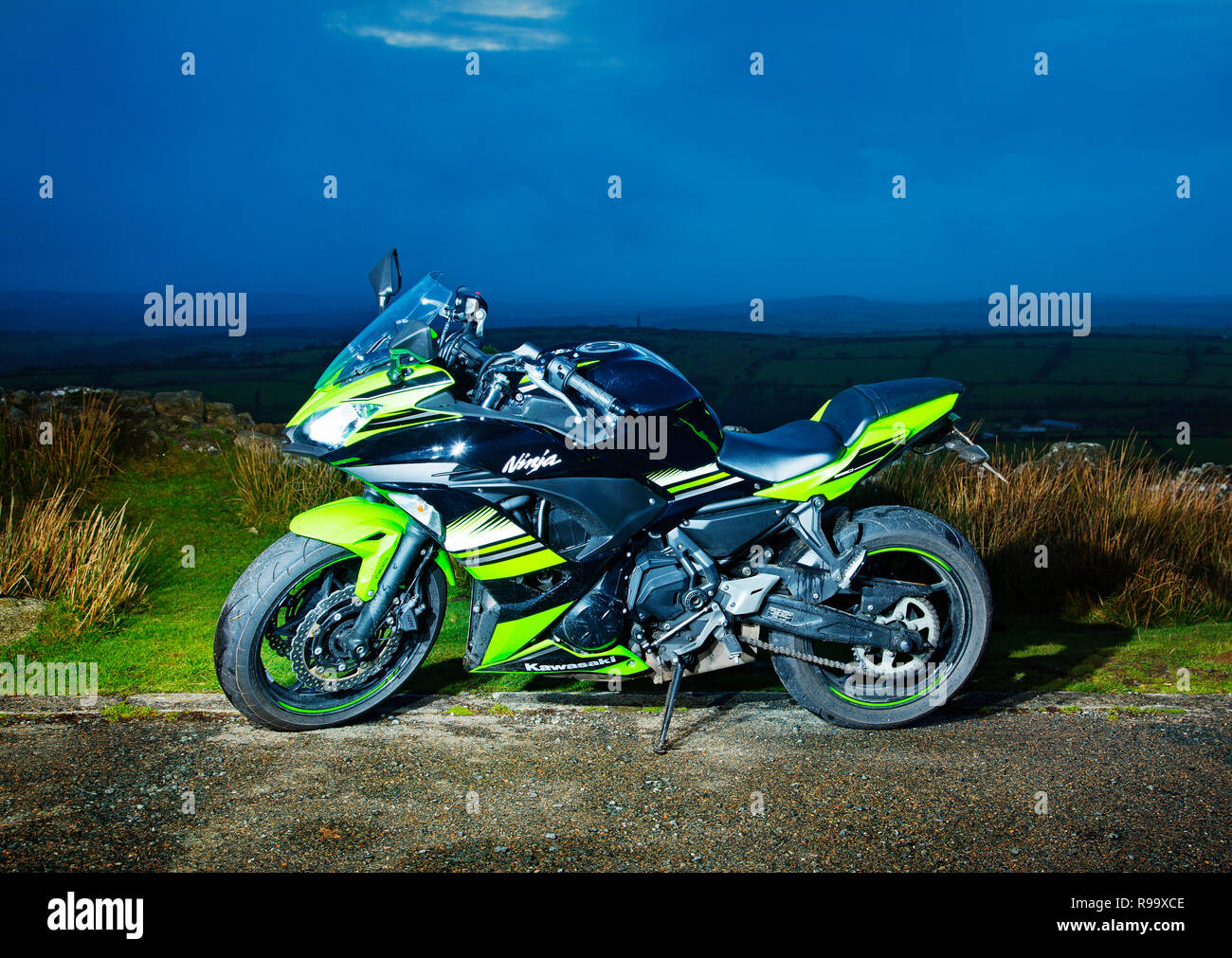 A motorbike parked up at dusk Stock Photo