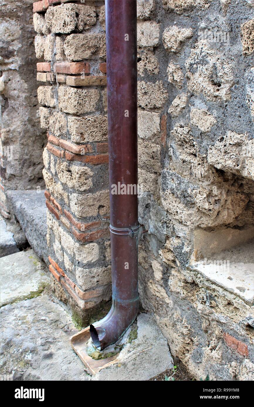 A well preserved lead pipe from within the ancient city of Pompeii, Italy, which was destroyed by the eruption of Mount Vesuvius volcano in 79AD. Stock Photo