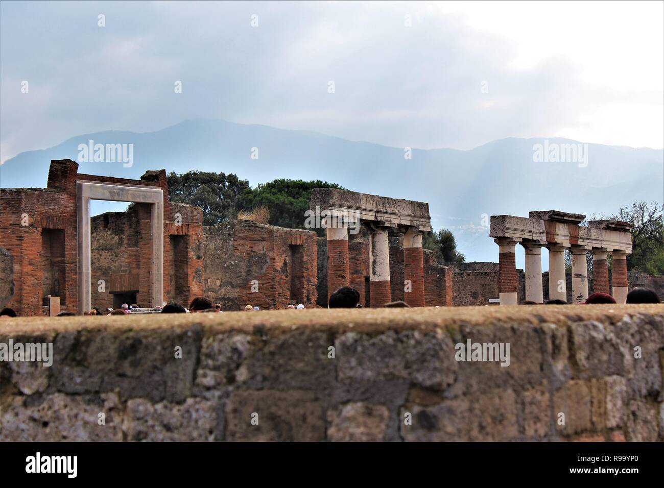Pompeii, Italy - October 23rd 2018: Tourists survey ruins of the ancient city of Pompeii that was destroyed by the eruption of Mount Vesuvius in 79AD. Stock Photo