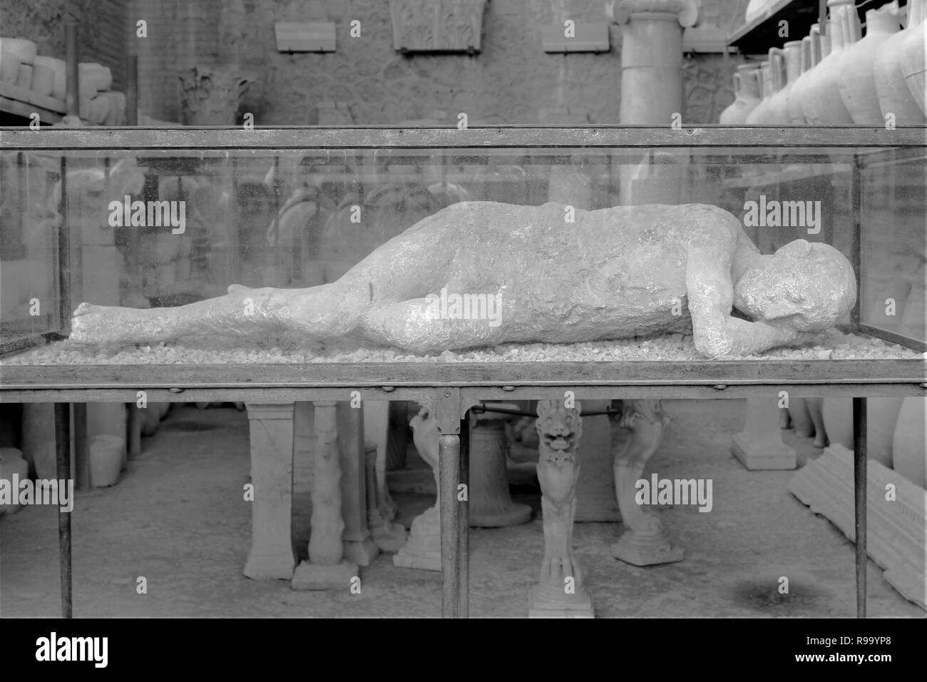 A plaster casting of the remains of a person showing their position at the time of death, at the archaeological site of the ancient city of Pompeii. Stock Photo