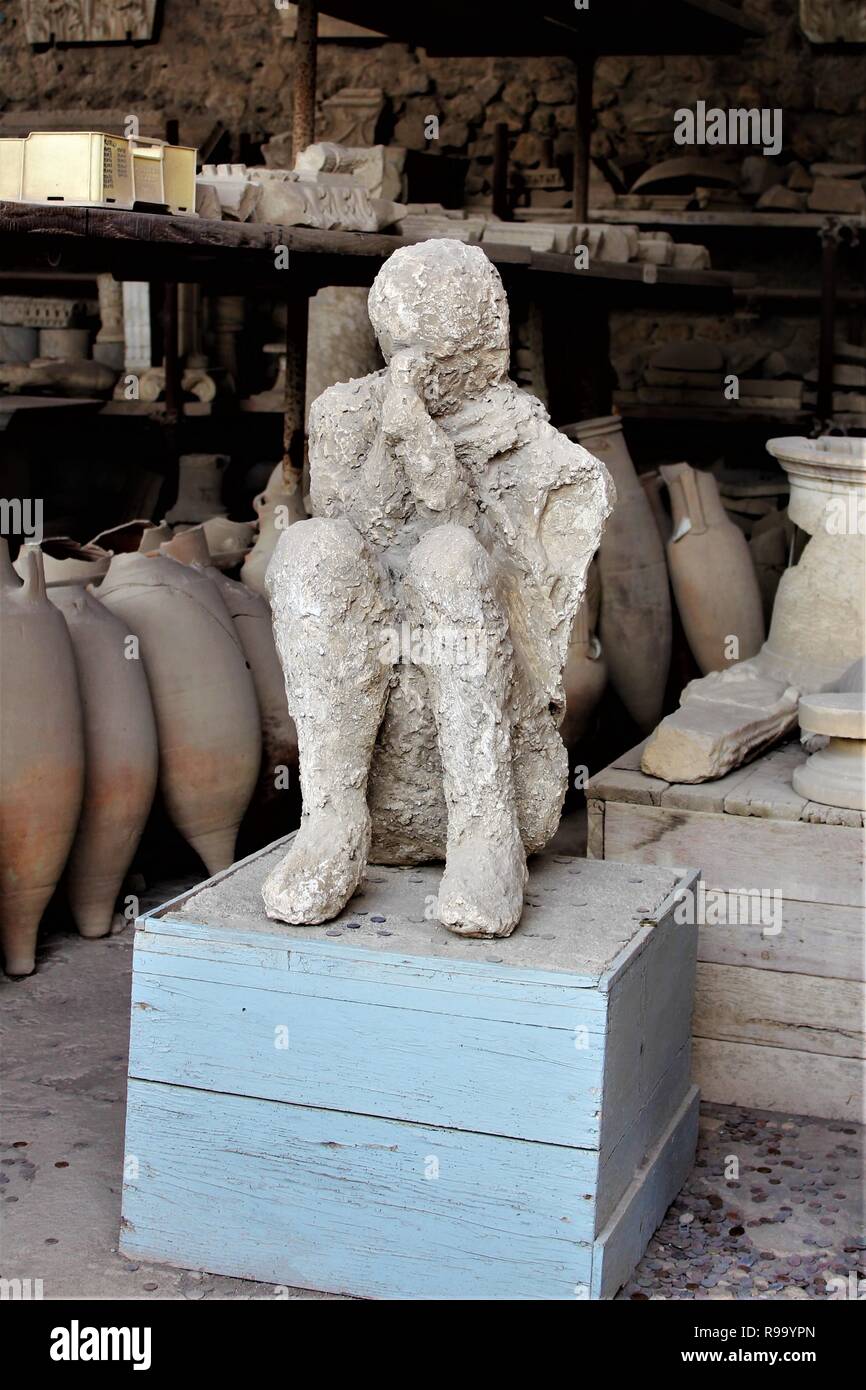 A plaster casting of the remains of a human showing their position at the time of death, at the archaeological site of the ancient city of Pompeii. Stock Photo