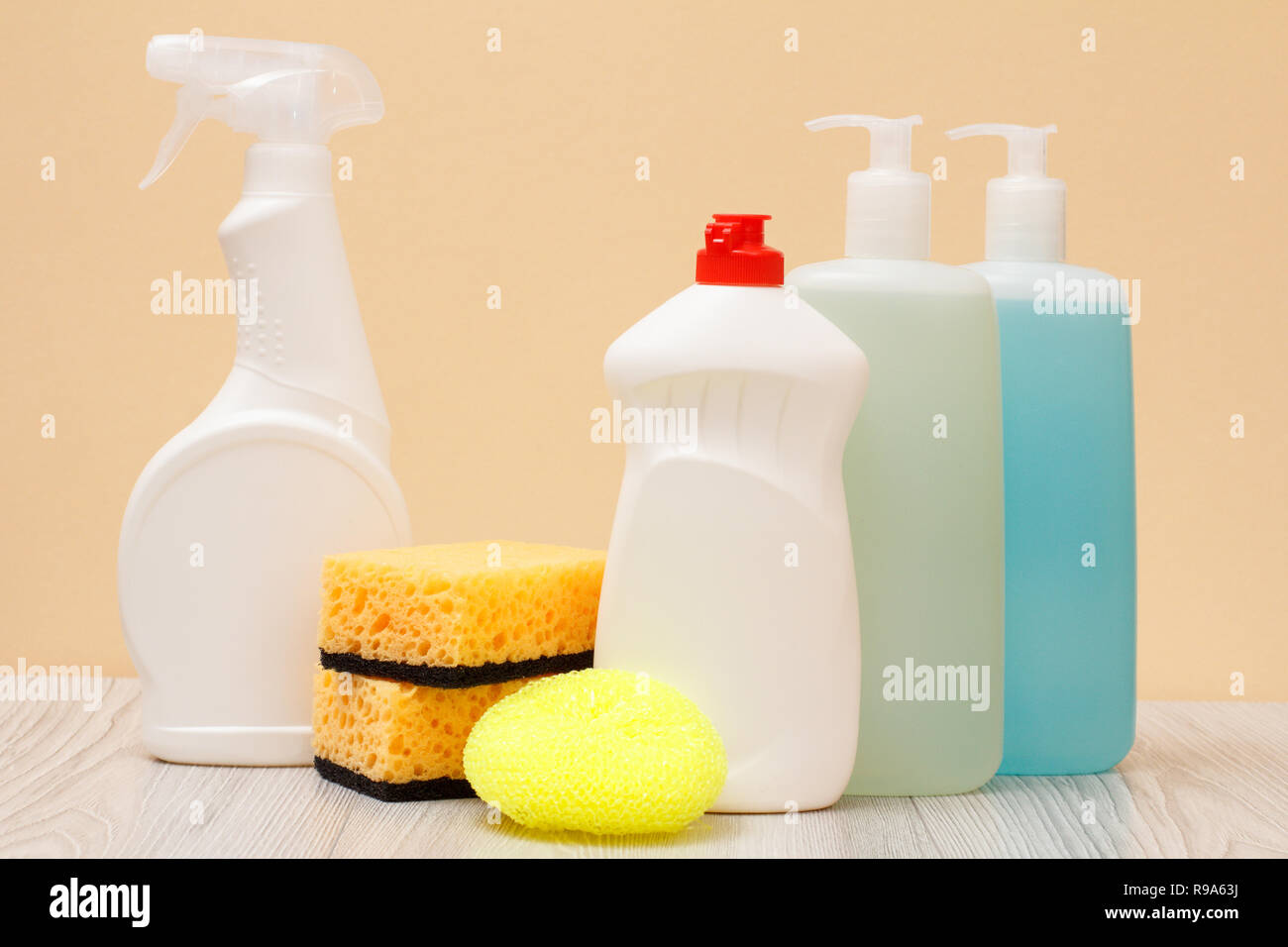 Plastic bottles of dishwashing liquid, glass and tile cleaner