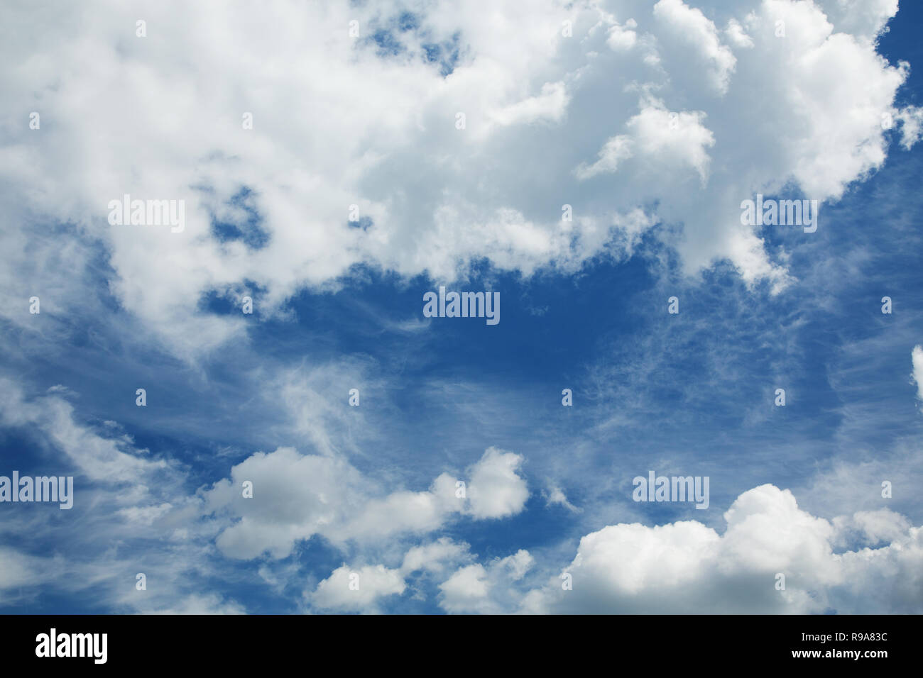 cumulus and cirrus clouds against a blue sky Stock Photo