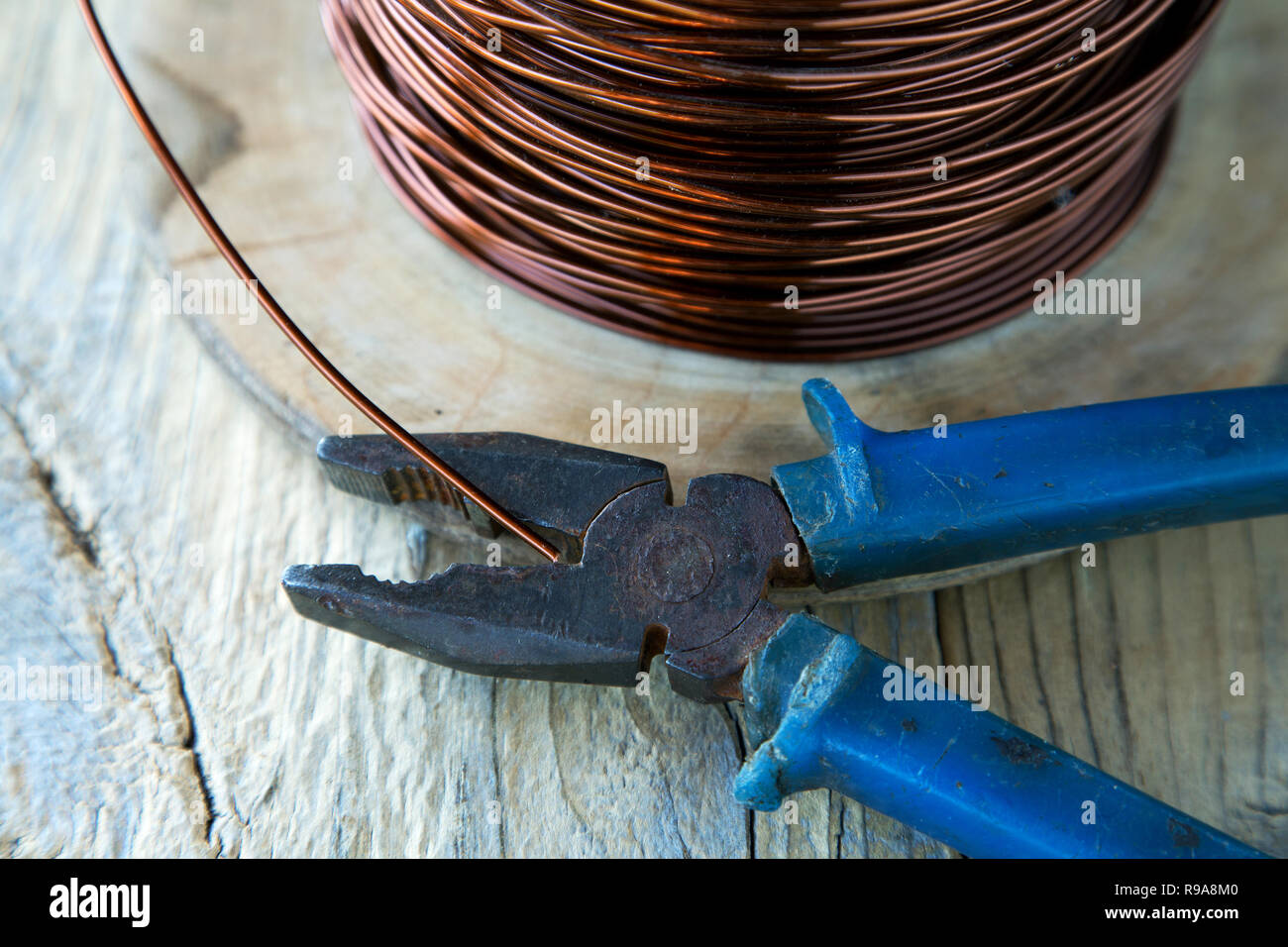 coil of copper wire and pliers close-up Stock Photo