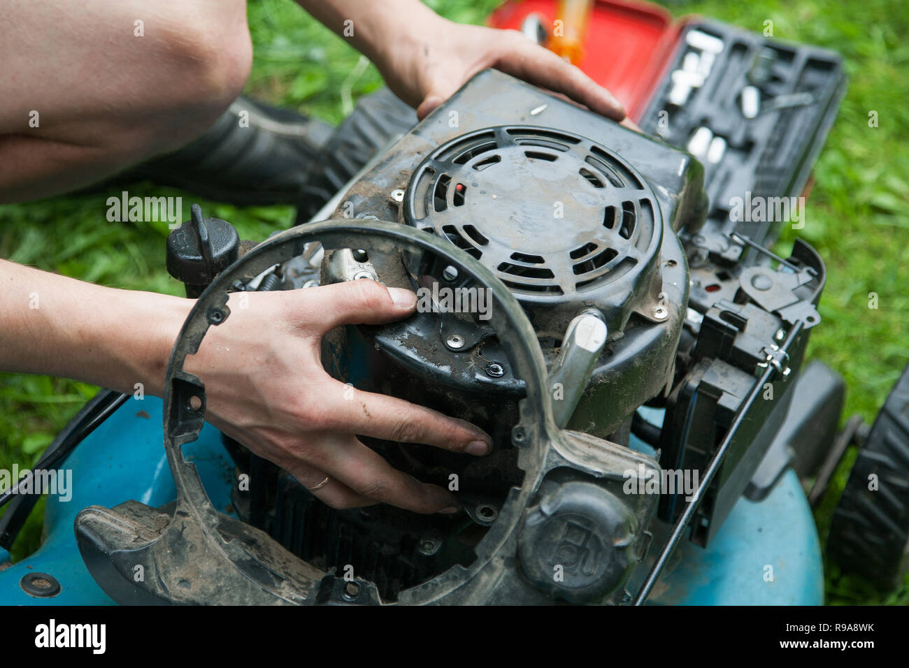 men's hands and gasoline engine repair closeup Stock Photo Alamy