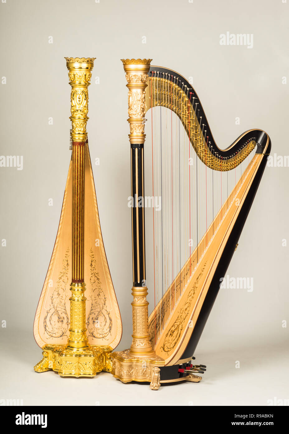 Studio shot of two Lyon and Healy Pedal harps style 23 in bronze and gold Stock Photo