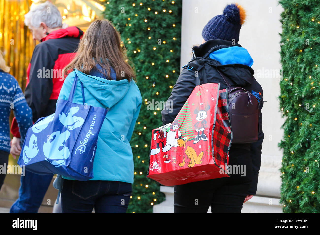 London, UK. 21st Dec, 2018. Women are seen with Disney shopping bags on London's Oxford Street with 3 days to Christmas Day.Retailers are expecting a rush of shoppers in the lead-up to Christmas with a number of stores starting their Winter Sales. Credit: Dinendra Haria/SOPA Images/ZUMA Wire/Alamy Live News Stock Photo