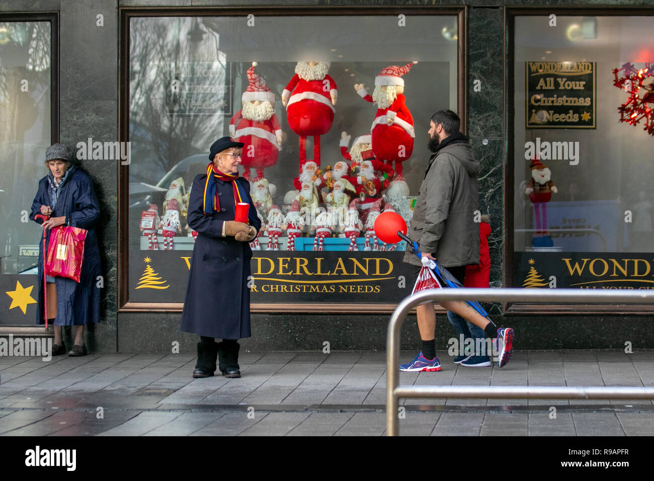 Southport, Merseyside, UK.  22nd Dec, 2018. Salvation Army volunteer and Christmas shopper in the town centre. Credit: MediaWorldImages/Alamy Live News Stock Photo