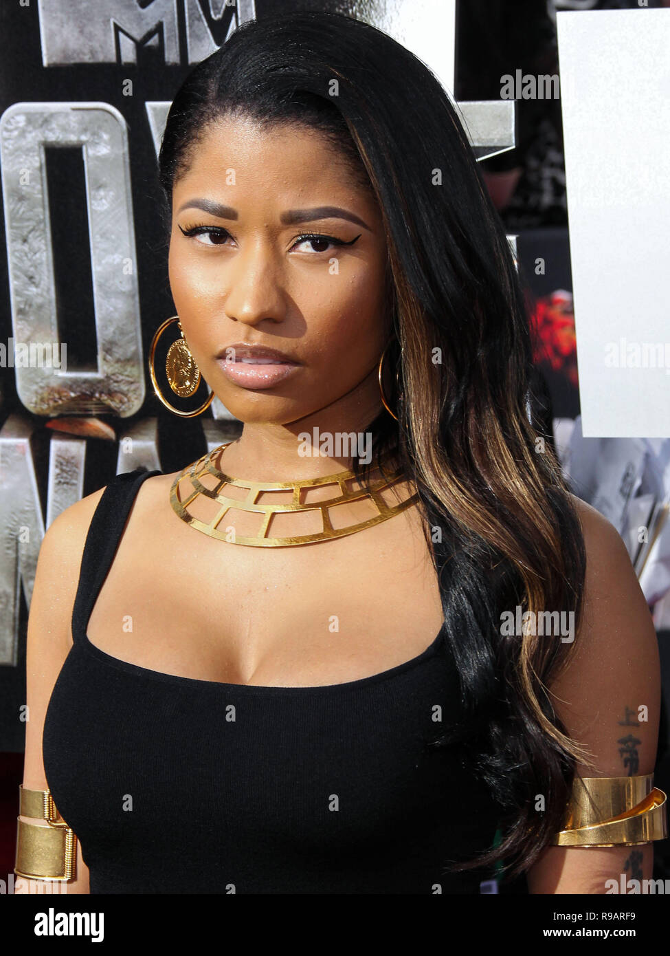 (FILE) Nicki Minaj Renamed Her Tour To 'The Nicki WRLD Tour' And Replaced Future With Juice WRLD. Nicki Minaj has finally revealed details surrounding her upcoming world tour 'The Nicki WRLD Tour'. Nicki has swapped out rap superstar Future with Chicago rap star Juice WRLD and she has cleverly renamed the outing from 'NickiHndrxx' to 'The Nicki WRLD Tour'. LOS ANGELES, CA, USA - APRIL 13: Rapper Nicki Minaj wearing a floor-length, black gown by Alexander McQueen, with gold cuffs, a large gold necklace and a gorgeous ring by John Hardy arrives at the 2014 MTV Movie Awards held at Nokia Theatre  Stock Photo
