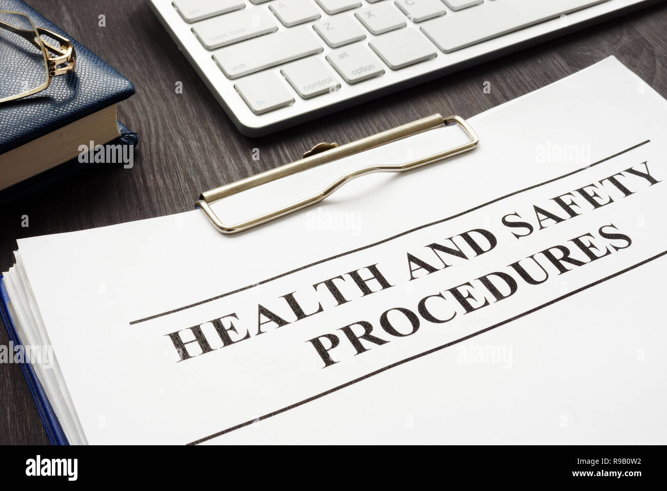 Clipboard with health and safety procedures on the table. Stock Photo