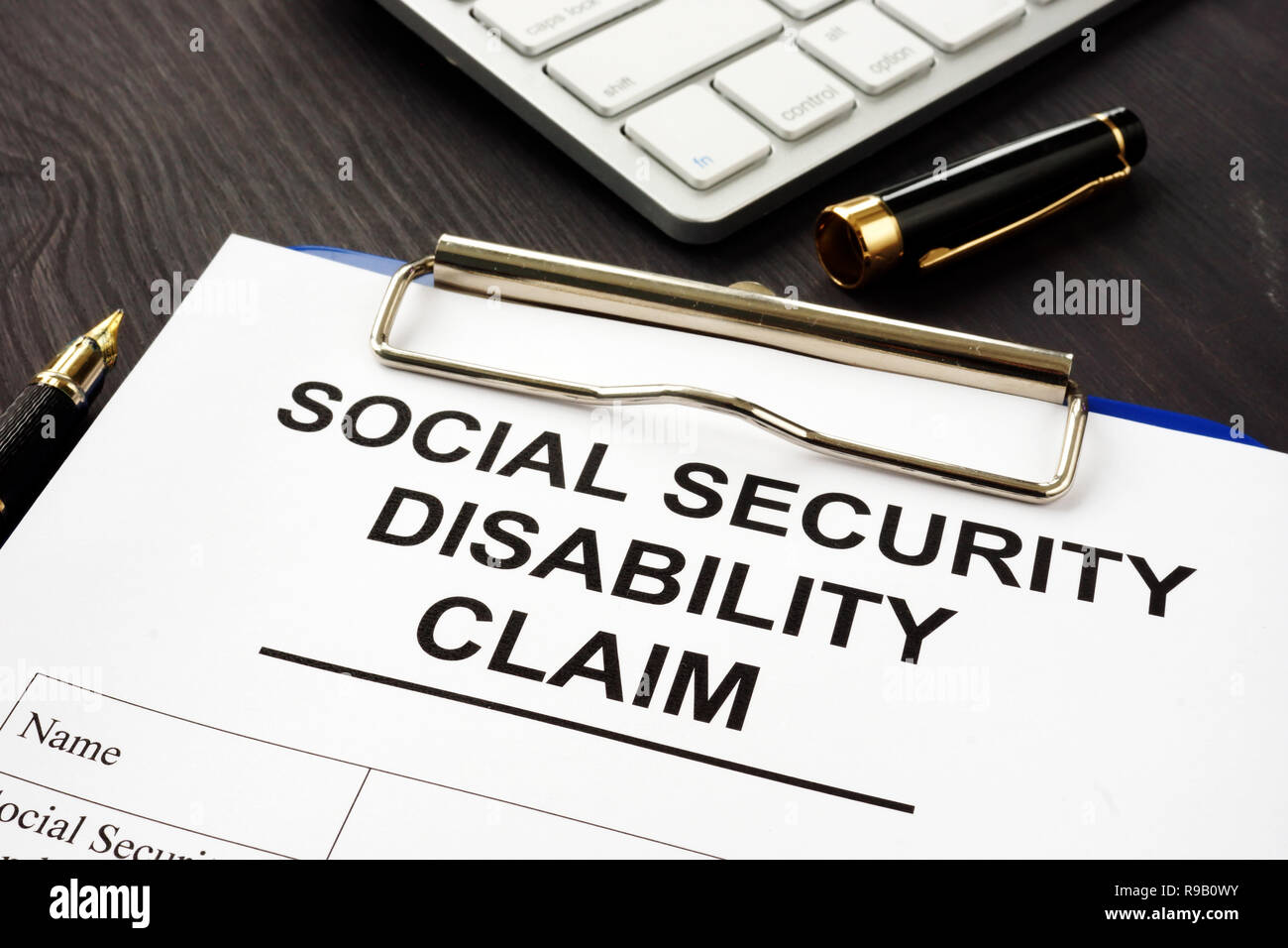 Social security disability benefits claim and pen. Stock Photo