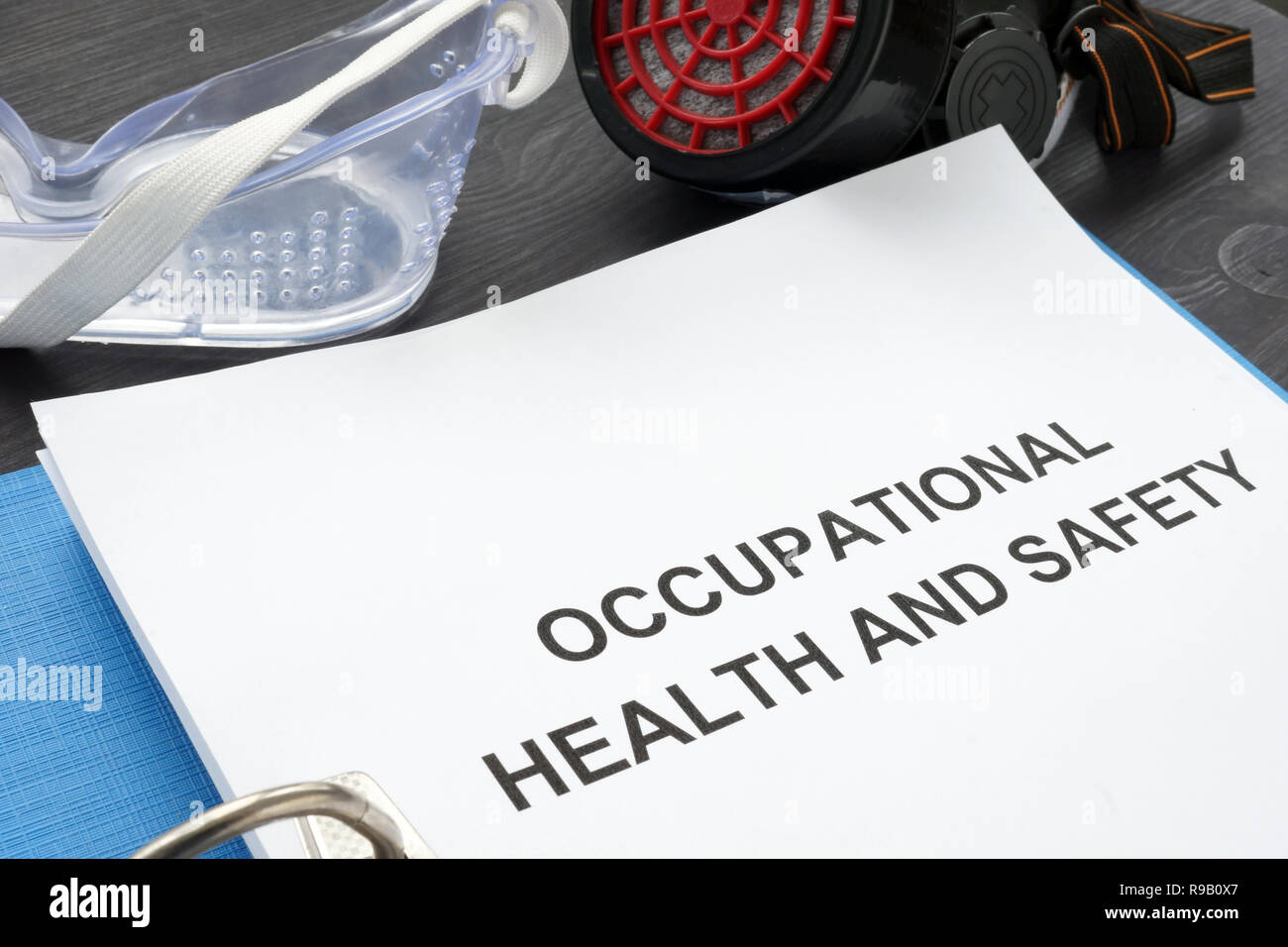 Occupational health and safety ohs act with blue folder Stock Photo Alamy