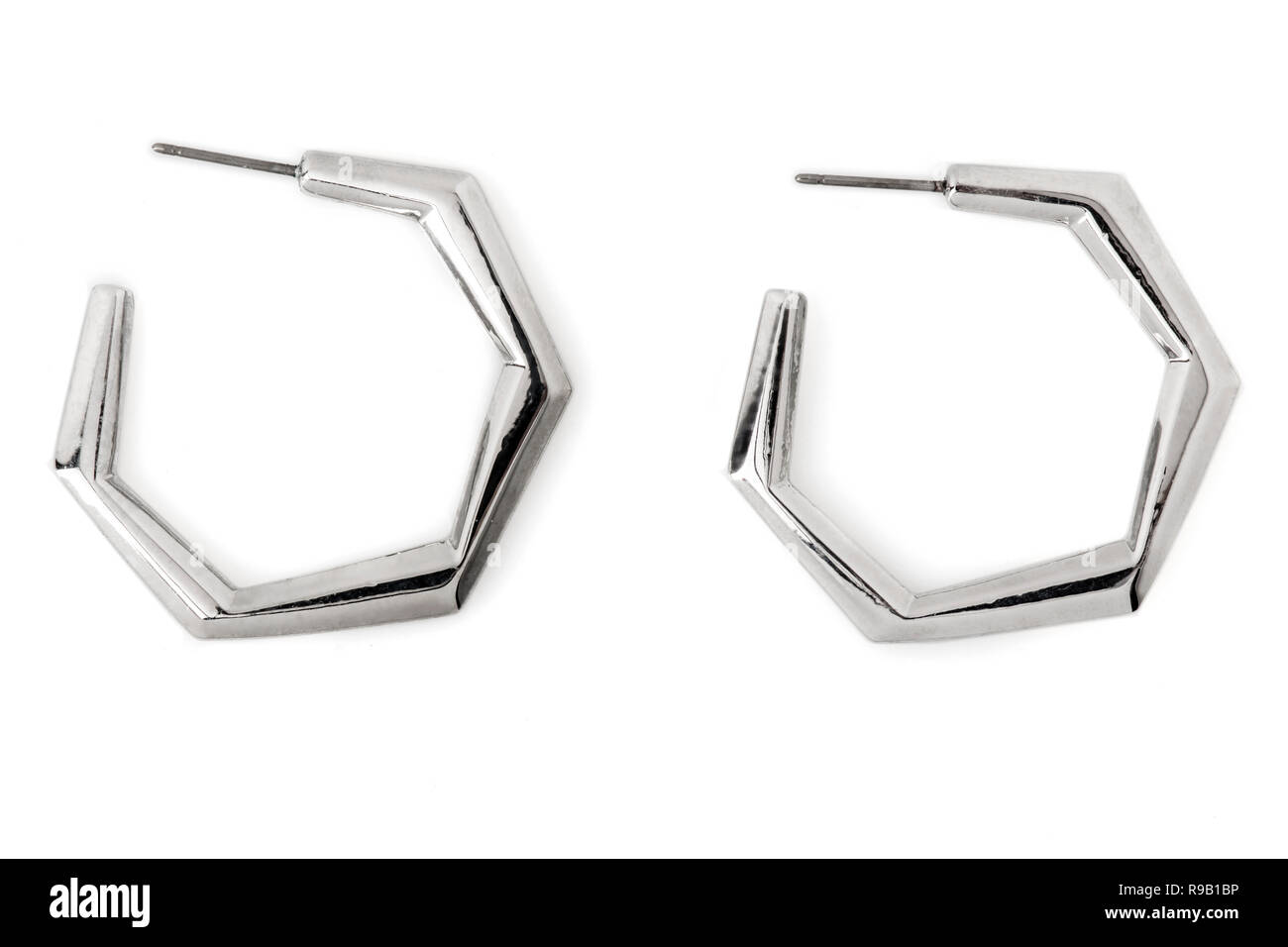 Hexagonal-shaped Silver Hoop Earrings isolated on white. Stock Photo