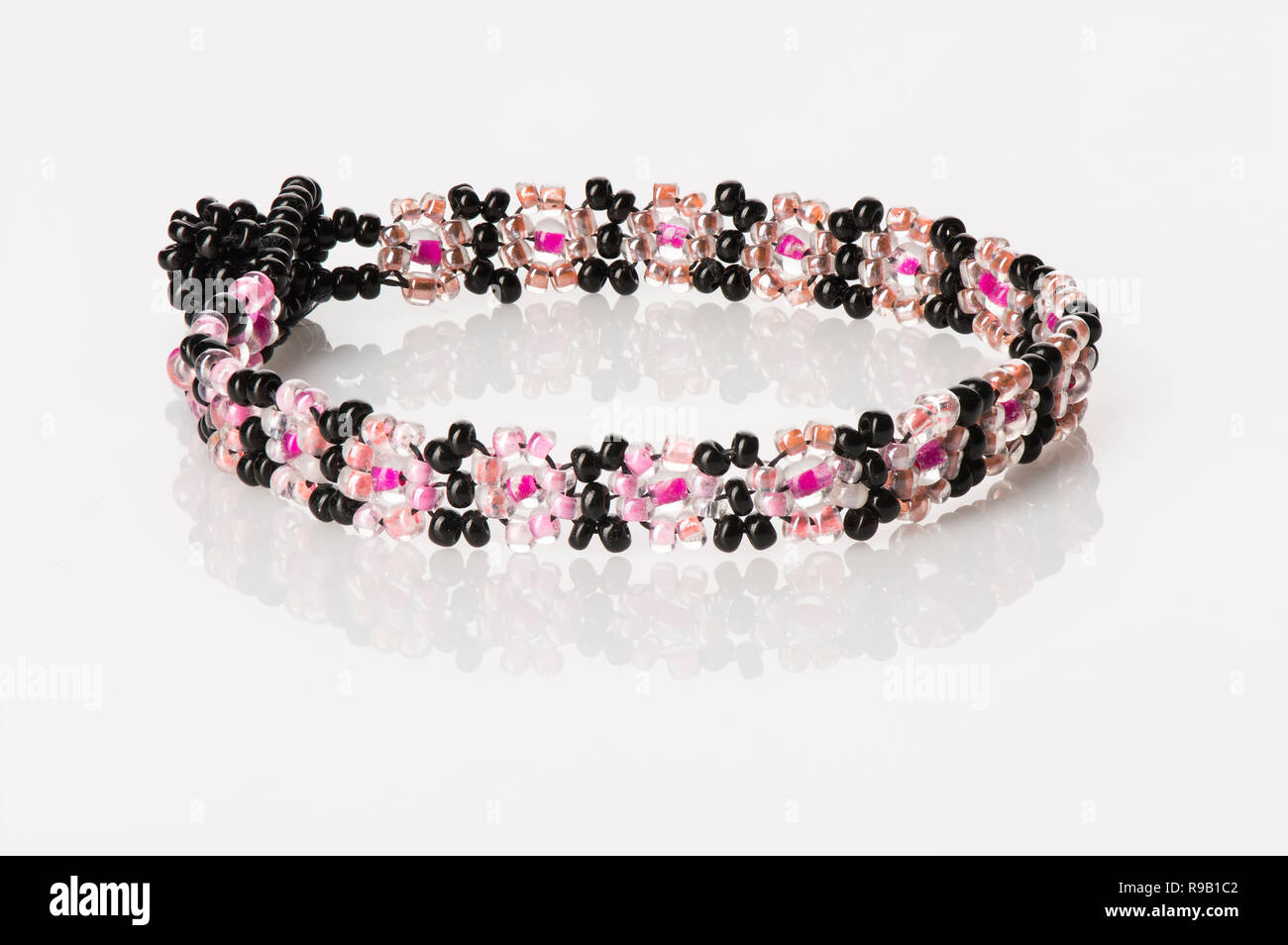 Women's Beaded Bracelet - Pink and Black, on white with reflection Stock Photo