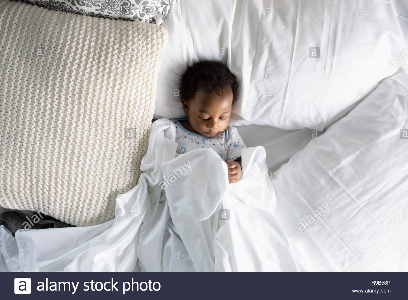 Black baby sleeping on bed hi-res stock photography and images - Alamy