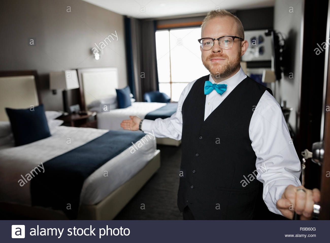 Butler opening the hotel door hires stock photography and images Alamy