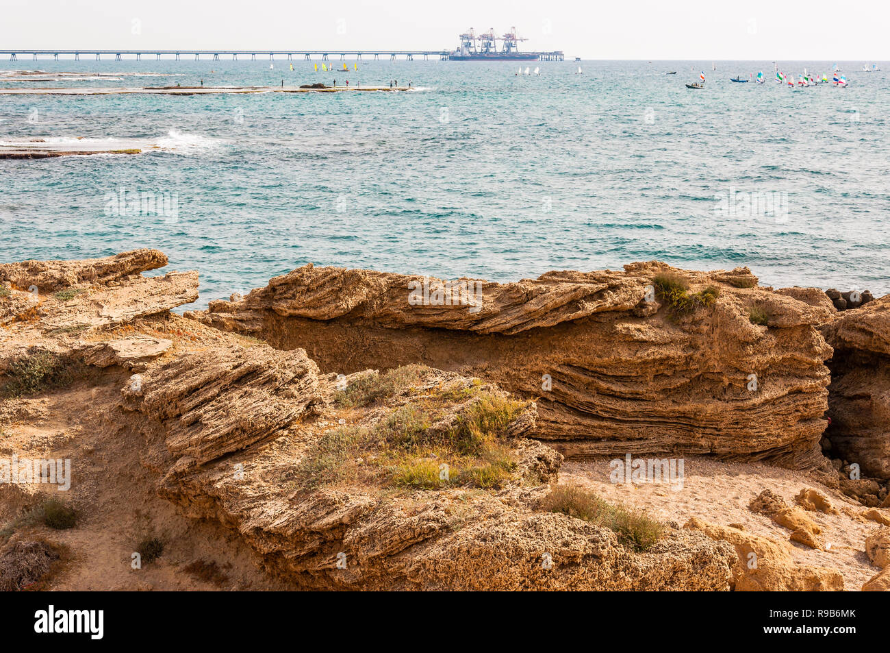 Caesarea, Israel - May 22, 2012: Rocks on the beach, fishing fishermen ...