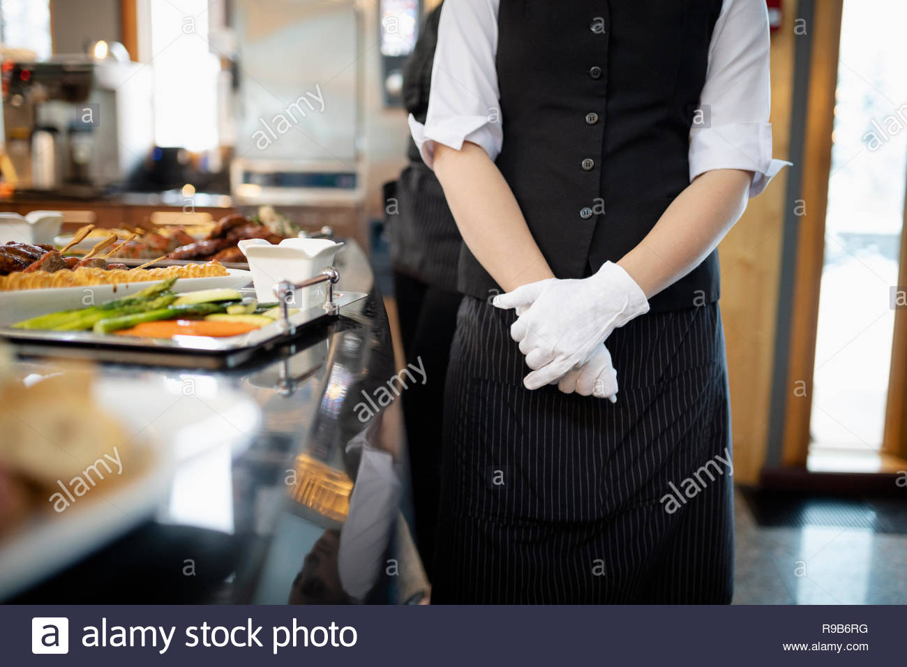 Female waitress wearing white gloves in restaurant Stock Photo Alamy