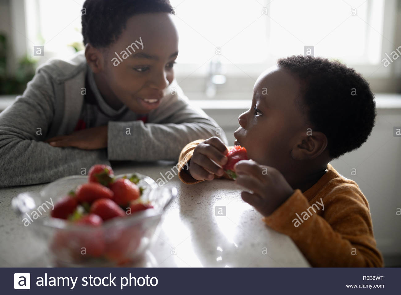 Brothers eating strawberries Stock Photo