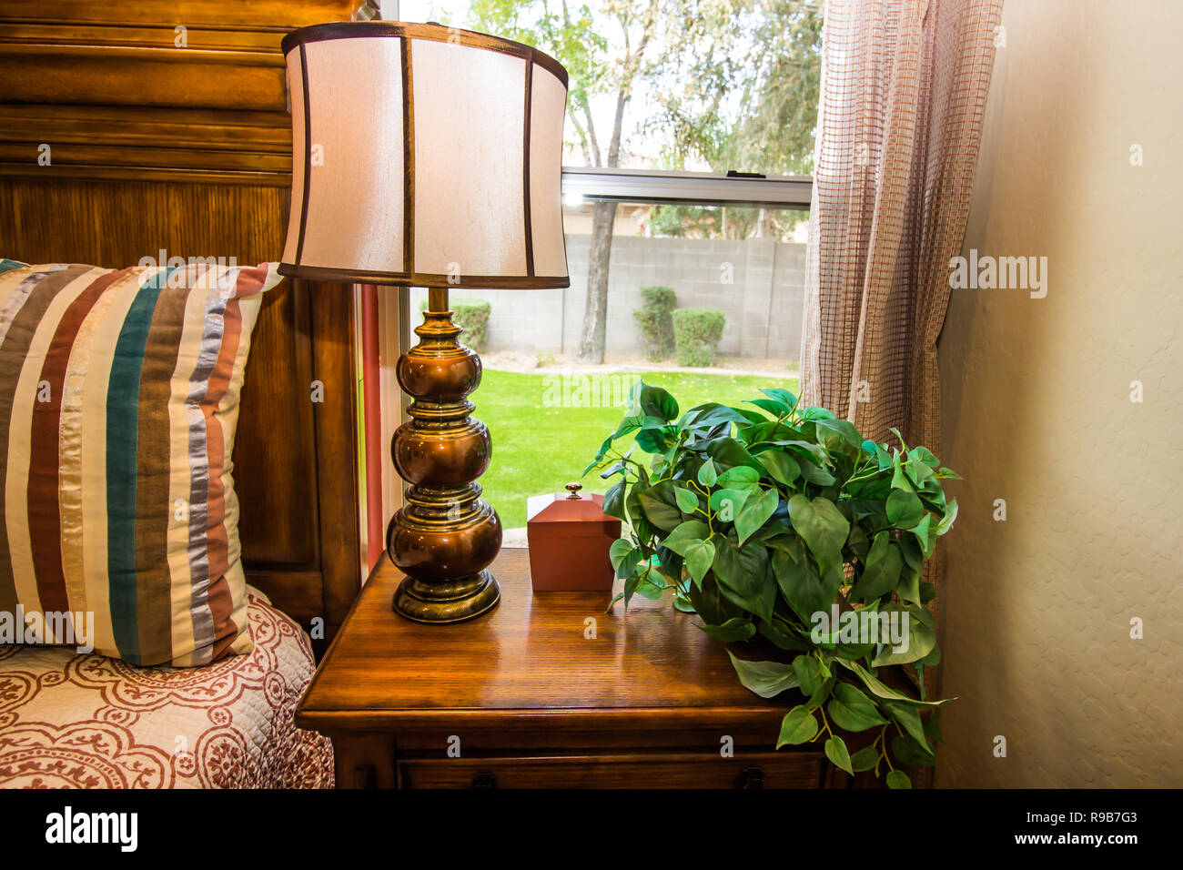 Bedroom With Bed Brass Lamp And Wooden Night Stand Stock Photo Alamy