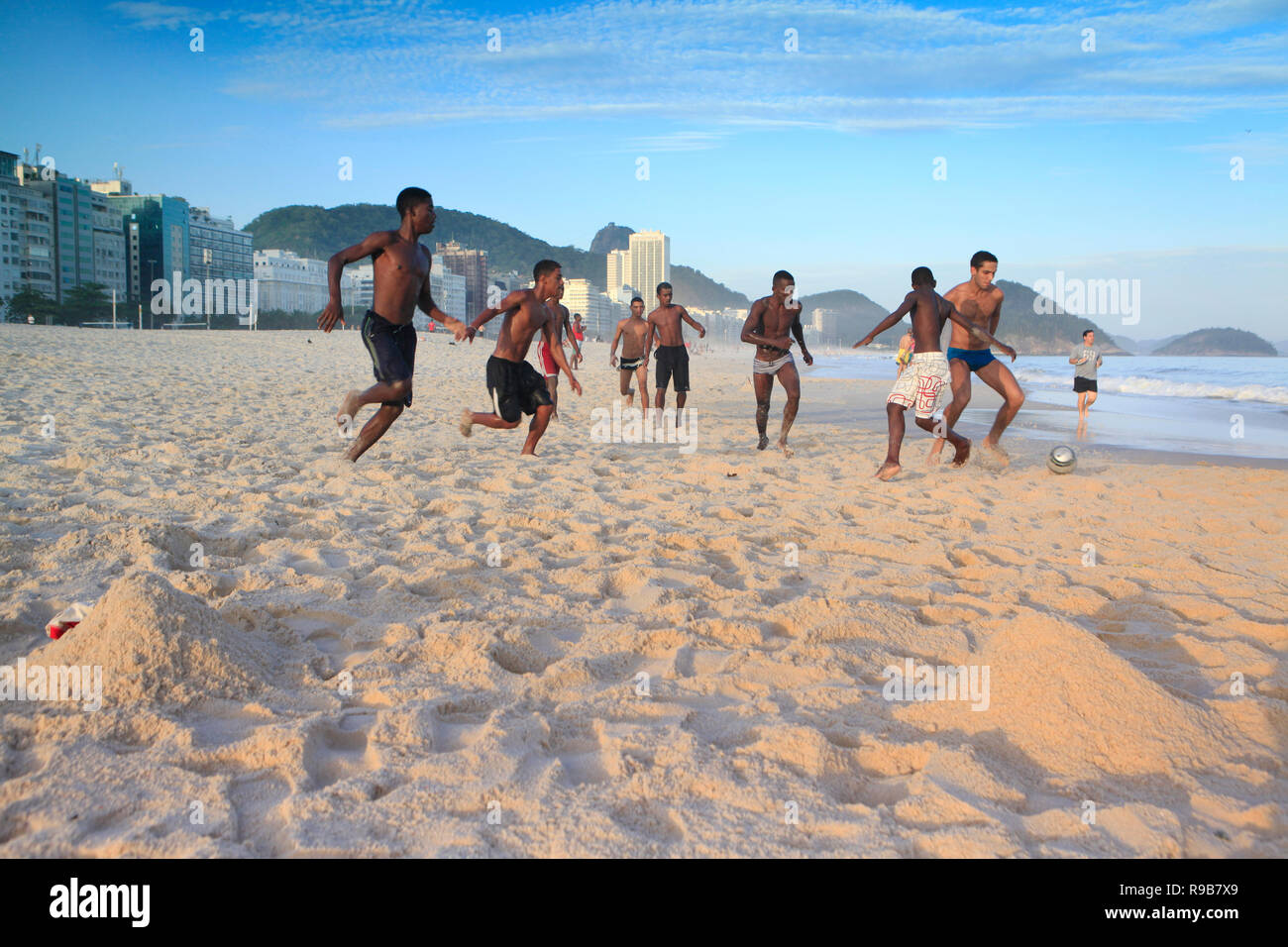 BRAZIL, Rio de Janiero, a group of friends juggle a soccer ball on
