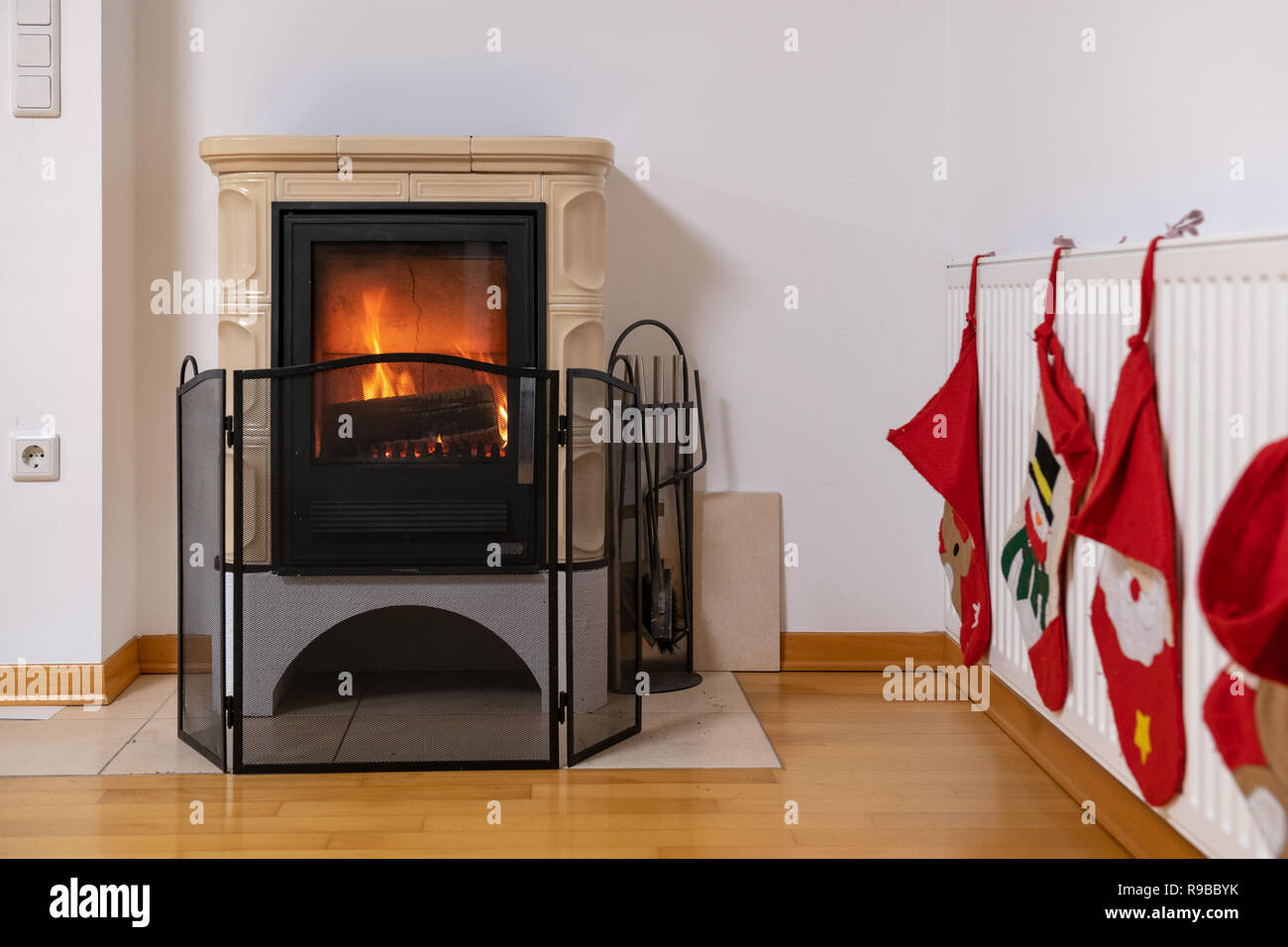 Tiled Stove With Fire Burning Inside Cosy And Warm Interior Scene