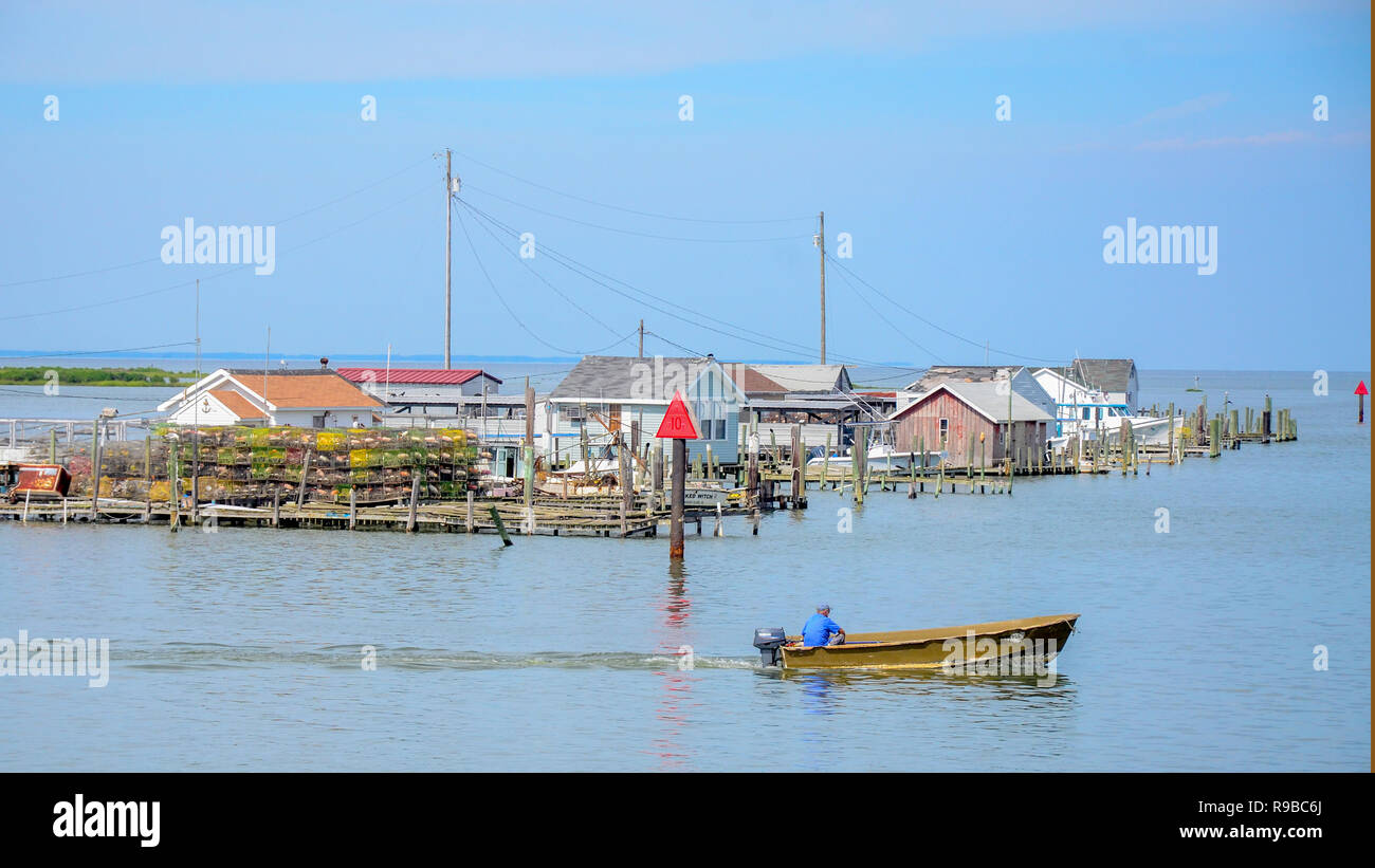 Tangier Channel is lined with fishermens docks, built on stilts in the water. Tangier island is sinking and has lost nearly 70 percent of its landmass Stock Photo