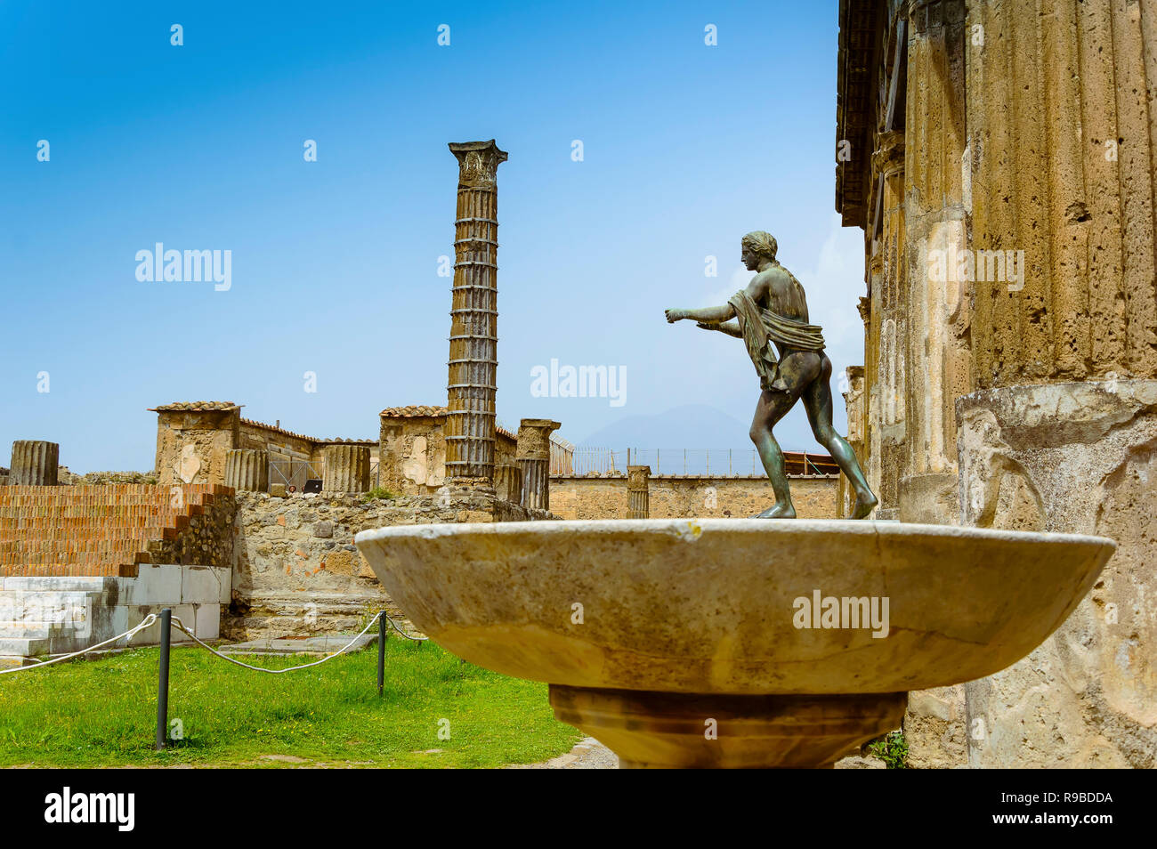 Pompeii ruins Temple of Apollo with bronze Apollo statue. Remains of