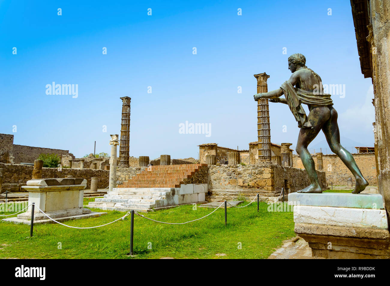 Pompeii ruins Temple of Apollo with bronze Apollo statue. Remains of
