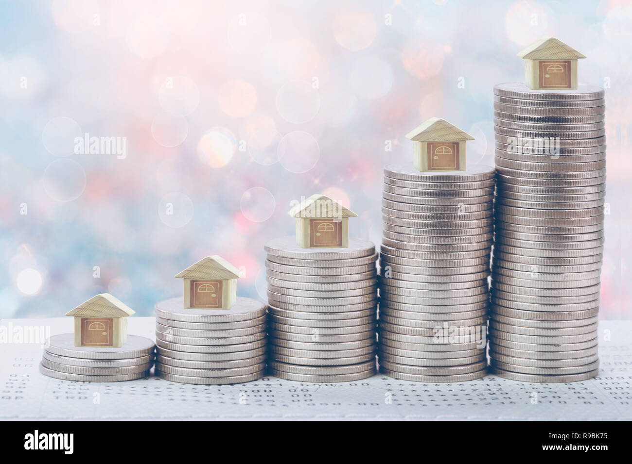 Coins stack in front of bank account book Savings money of coins concept concept for property ladder, mortgage and real estate investment.  for saving Stock Photo