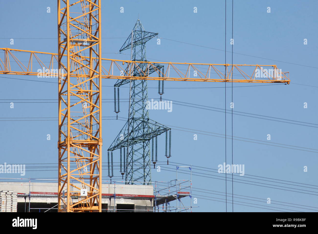Construction cranes, construction site, electricity pylon, power pylon