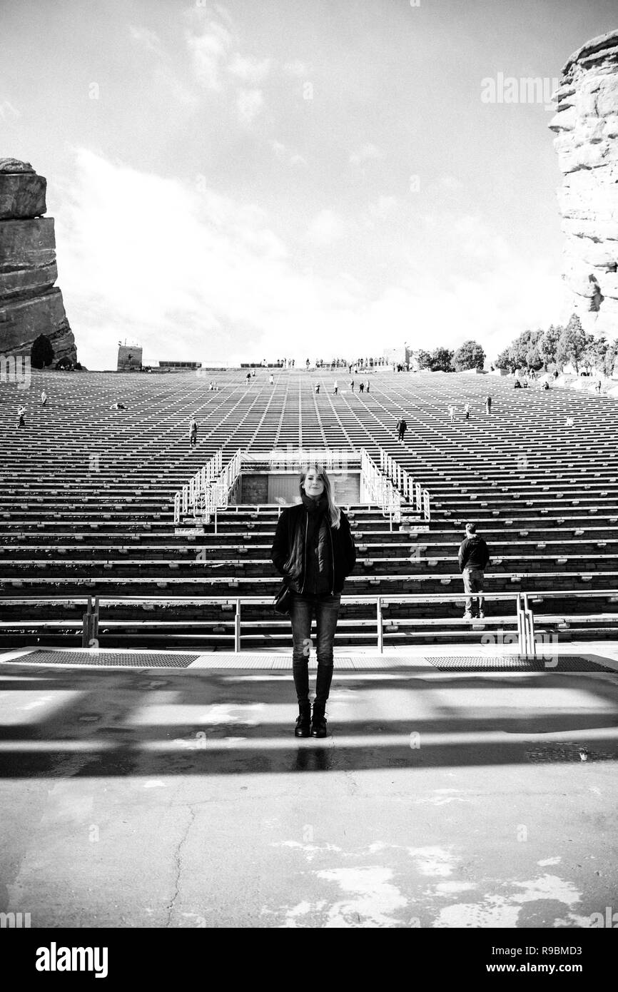 Portrait of Female Person Standing Front and Center on a Stage Dreaming and Imagining the Future while Facing Stadium Stands at Outdoor Amphitheater Stock Photo