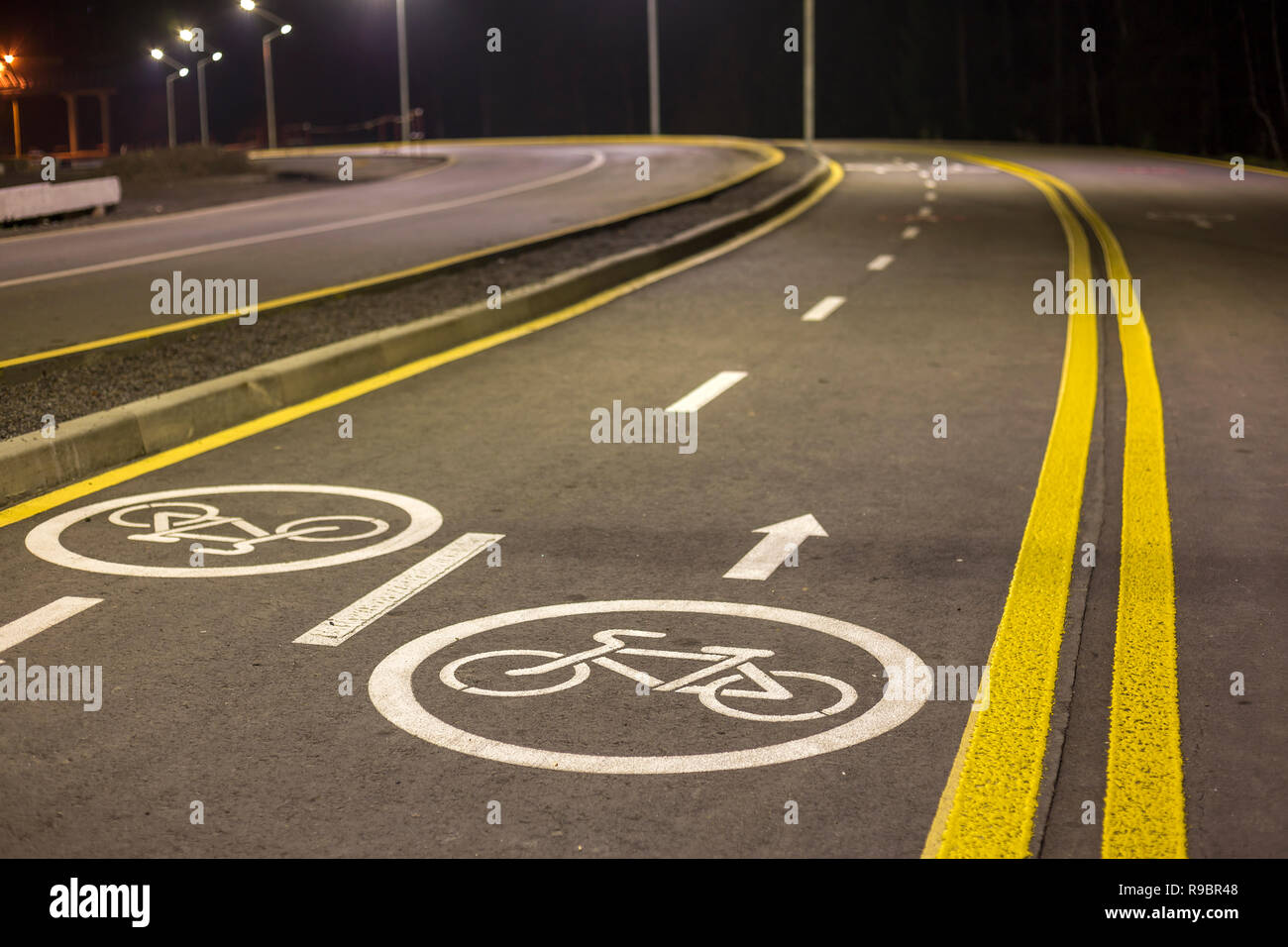 Bicycle Road Markings and Signs. Illuminated bicycle lane travel lane  reserved for bicyclists with pavement markings with arrows that direct  bicyclist Stock Photo - Alamy