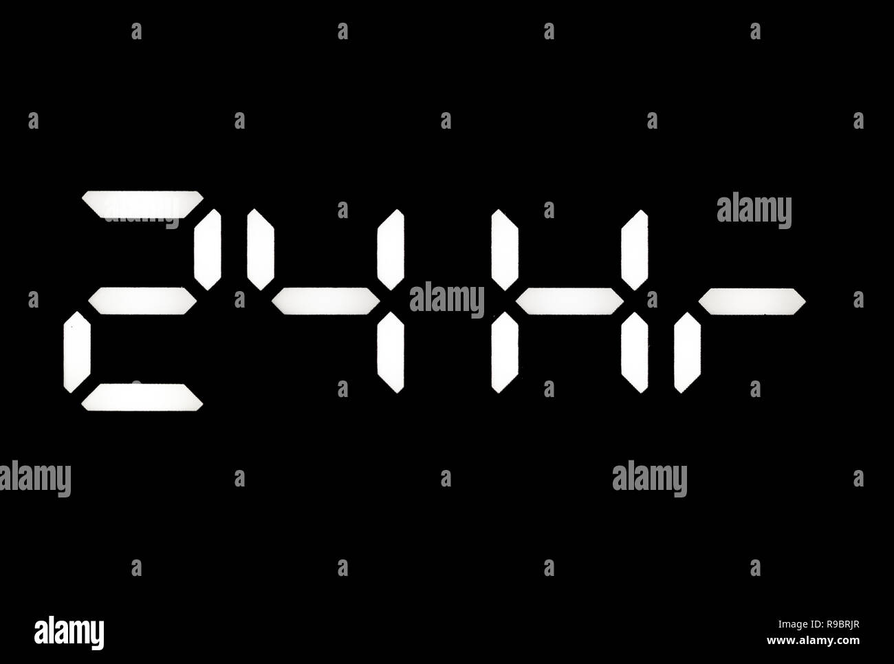 Real white led digital clock on a black background showing 24Hr Stock Photo