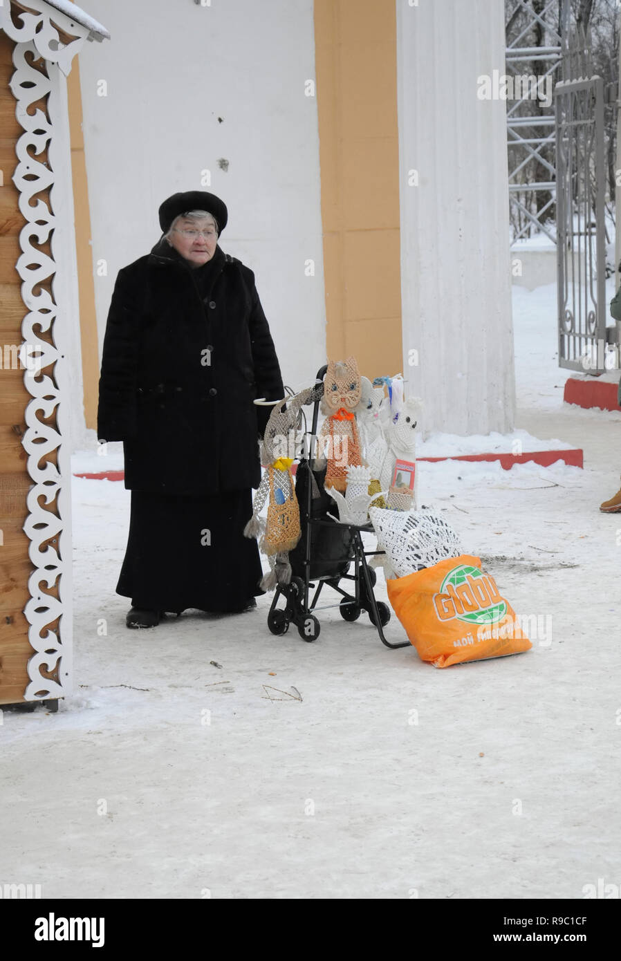 Kovrov, Russia. 28 December 2014. Festive fair before the New Year at Freedom Square. An elderly woman sells products from the macrame of its manufact Stock Photo