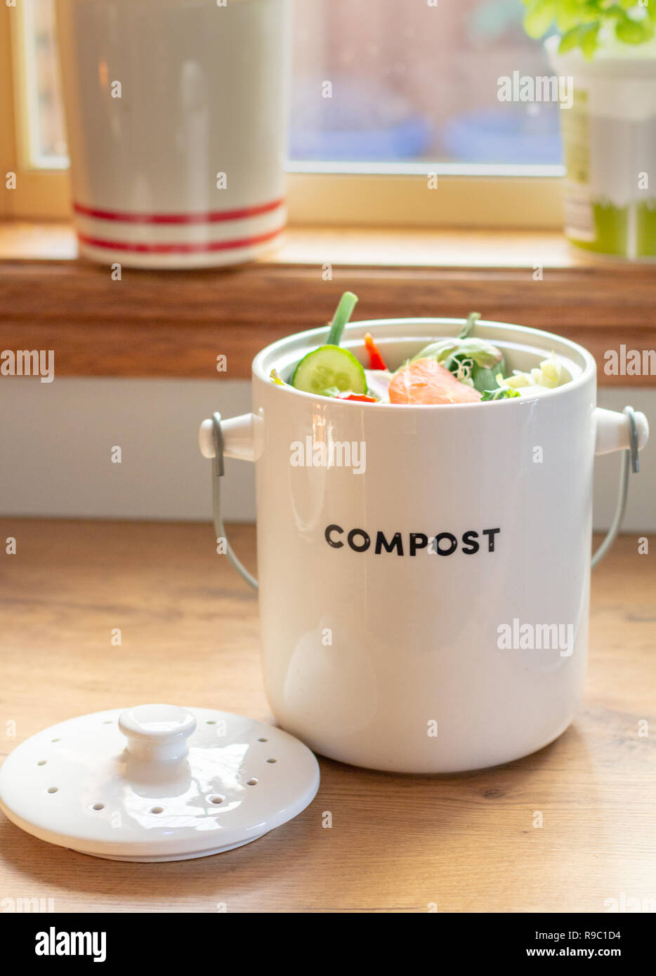 Recycle kitchen waste, sustainable living kitchen waste recycling, kitchen waste compost pot containing kitchen waste on kitchen counter top Stock Photo