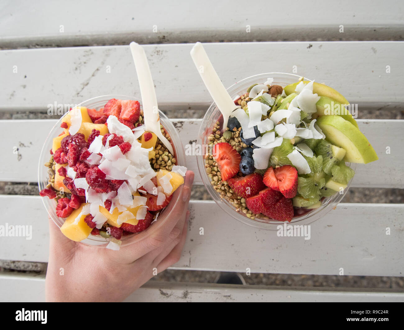 Bowl of acai and fruit healthy food on a bench ready to be eaten. Stock Photo