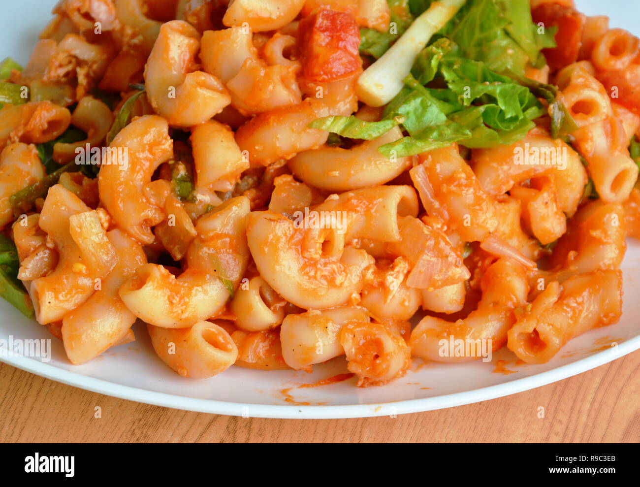 stir fried macaroni with egg and tomato sauce on white plate Stock Photo -  Alamy, image size:1300x989