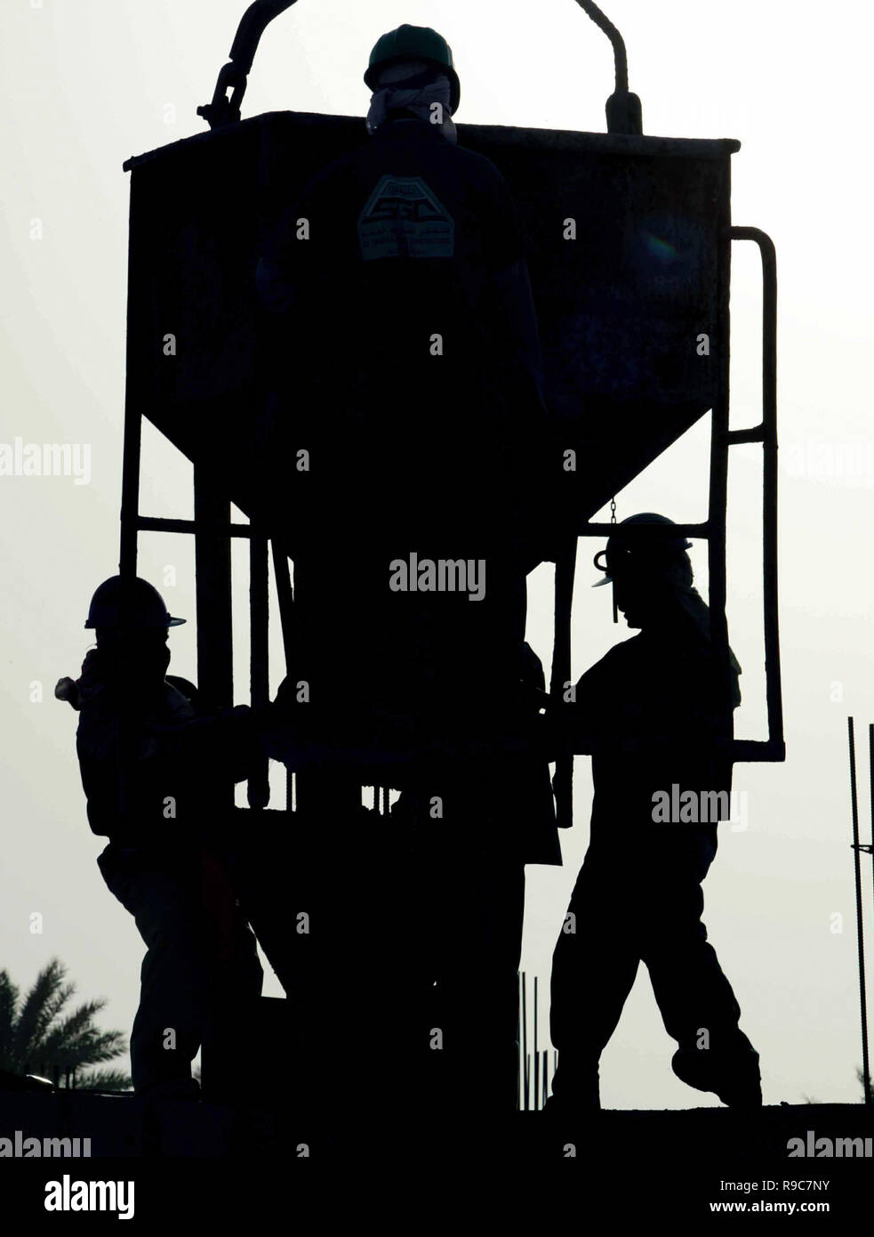 Dubai, United Arab Emirates, UAE - 14JUN2004: Workers silhouetted during the late afternoon while laying a building foundation in the Dubai Marina area which was a hub of hundreds of major construction projects, during the boom times. Stock Photo